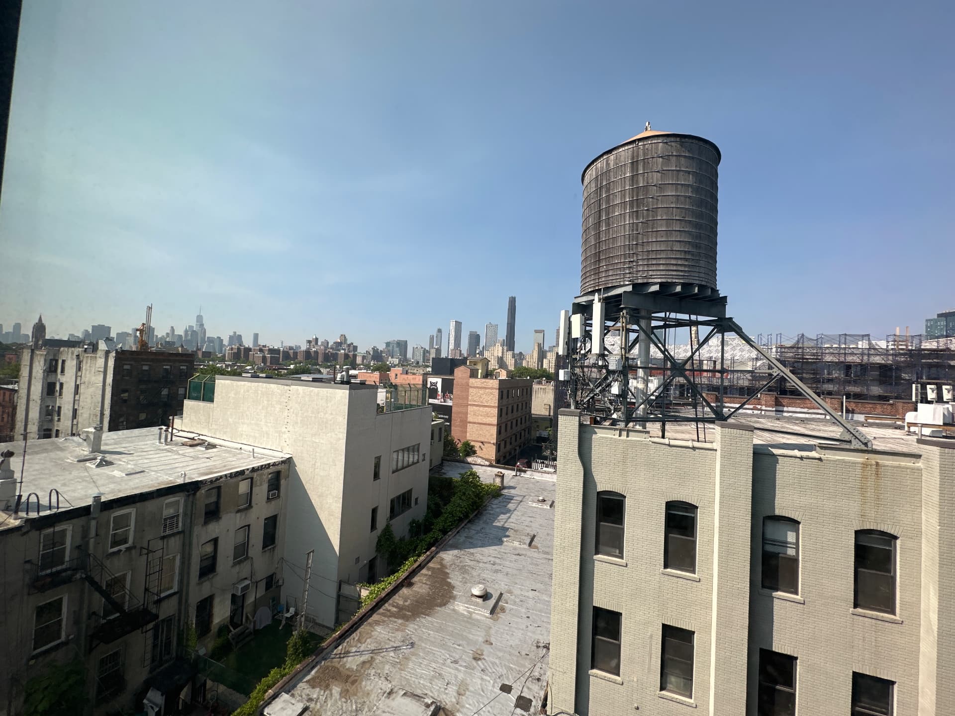 View from the upper floors of 497 Carroll Street over Gowanus rooftops toward the Manhattan skyline